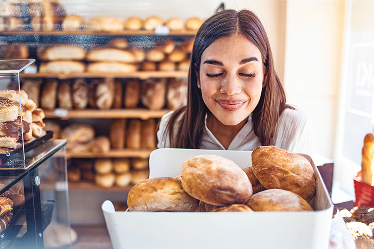 Bread Store Owner carrying basket of bread