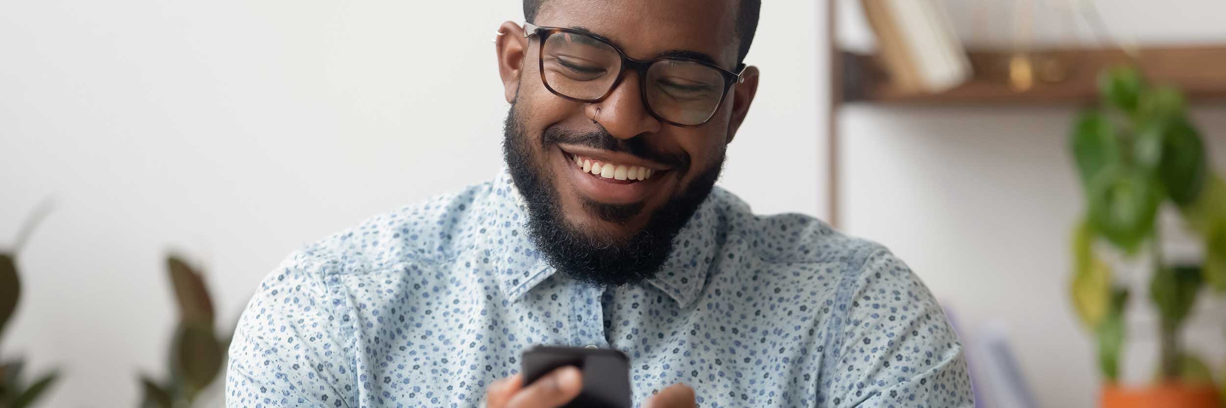 Happy Man looking at a video on phone